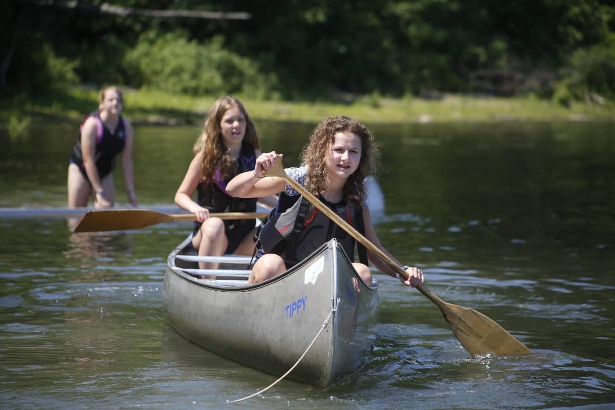 Girls going canoeing at lake