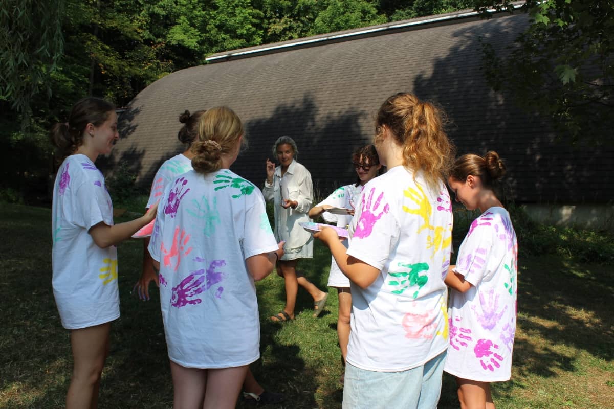 Camp counselor outdoors with a group of girls
