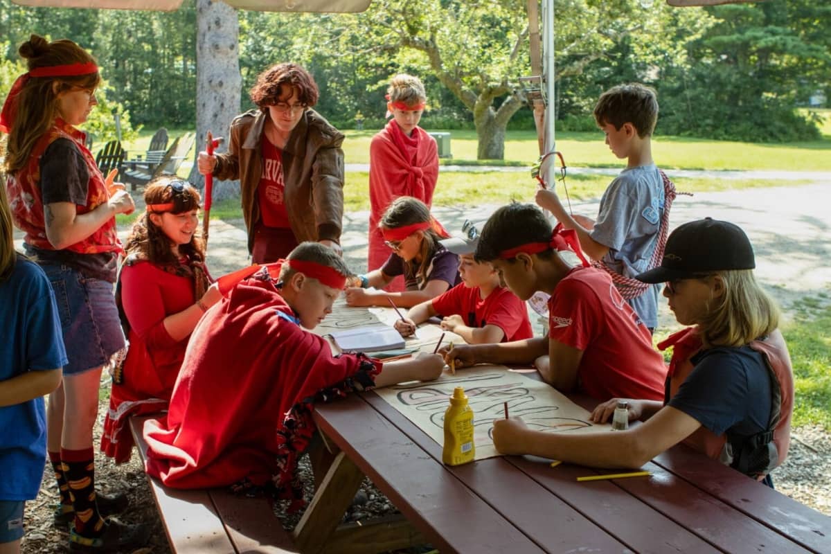 Boys and girls drawing on posters