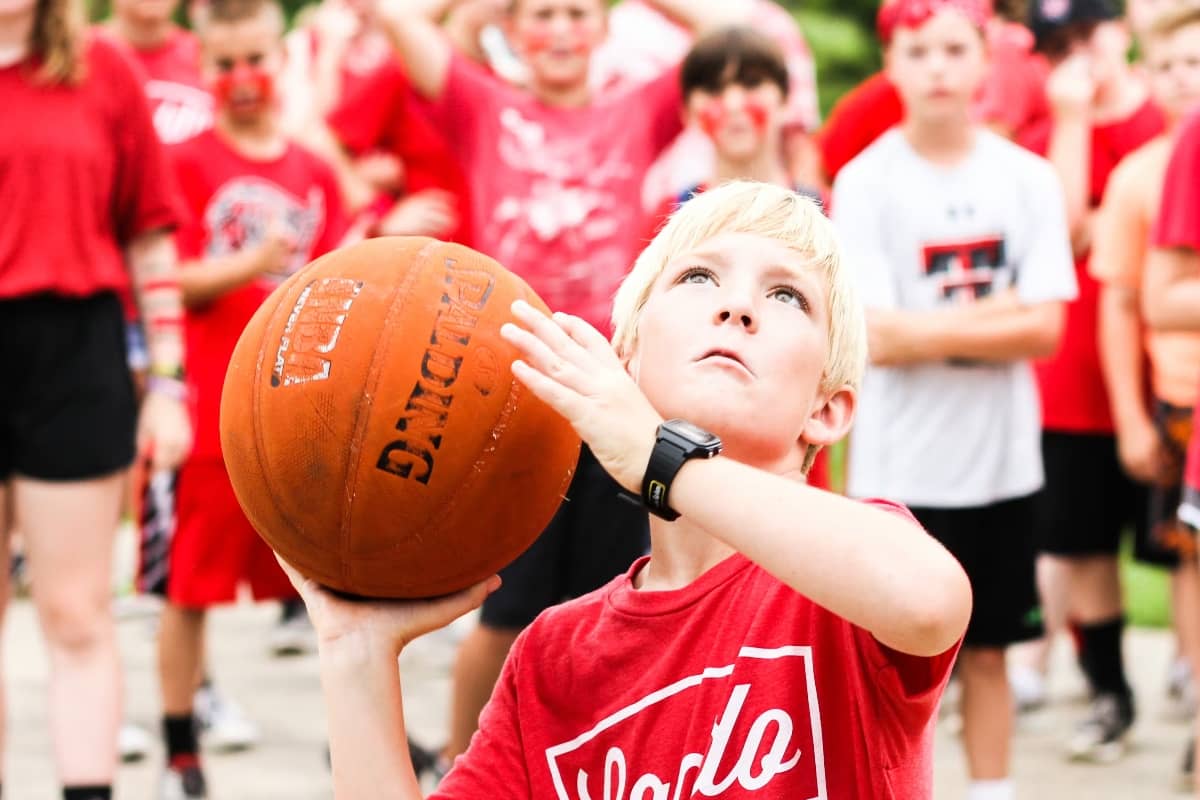 Boy about to throw basketball at Camp Huawni