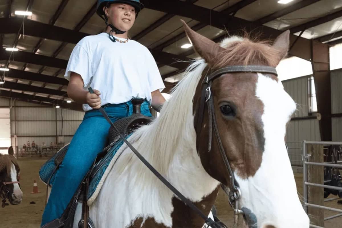 Boy going horseback riding at camp