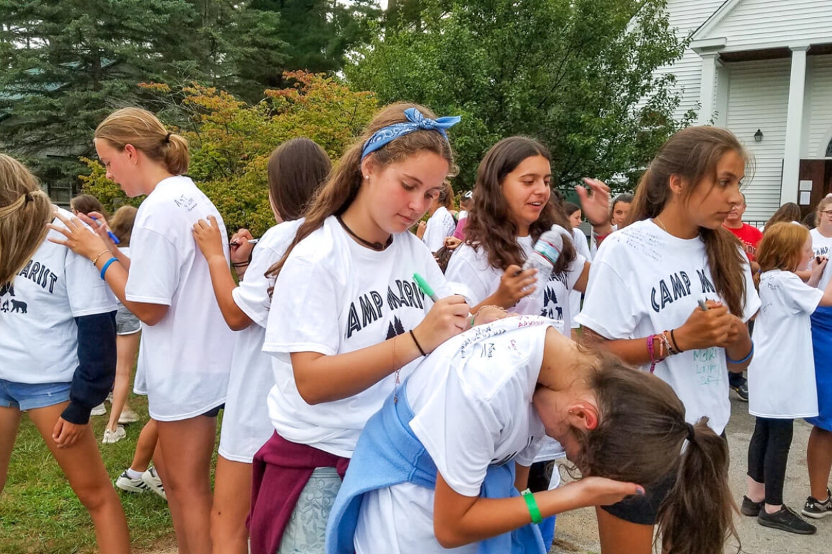Girls signing shirts