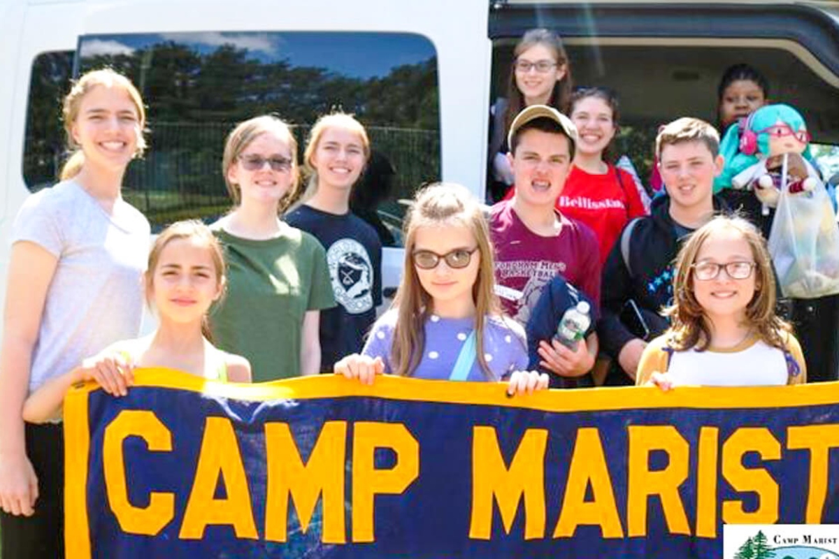 Campers holding up Camp Marist sign