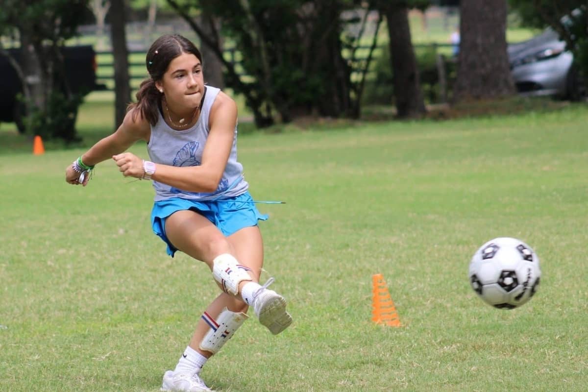 Girl playing soccer at Camp Olympia