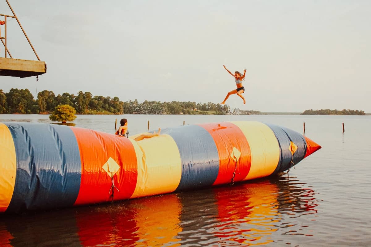 Campers jumping into lake at Camp Olympia