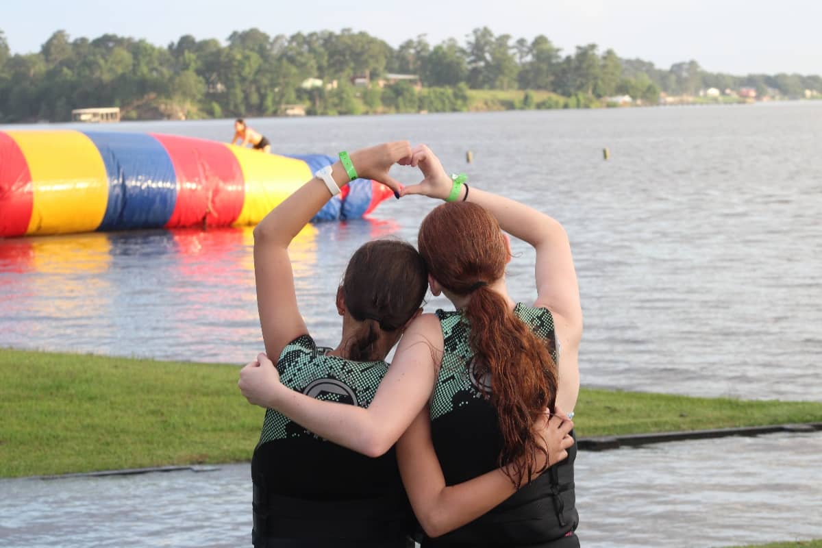 Two girls making a heart with their hands