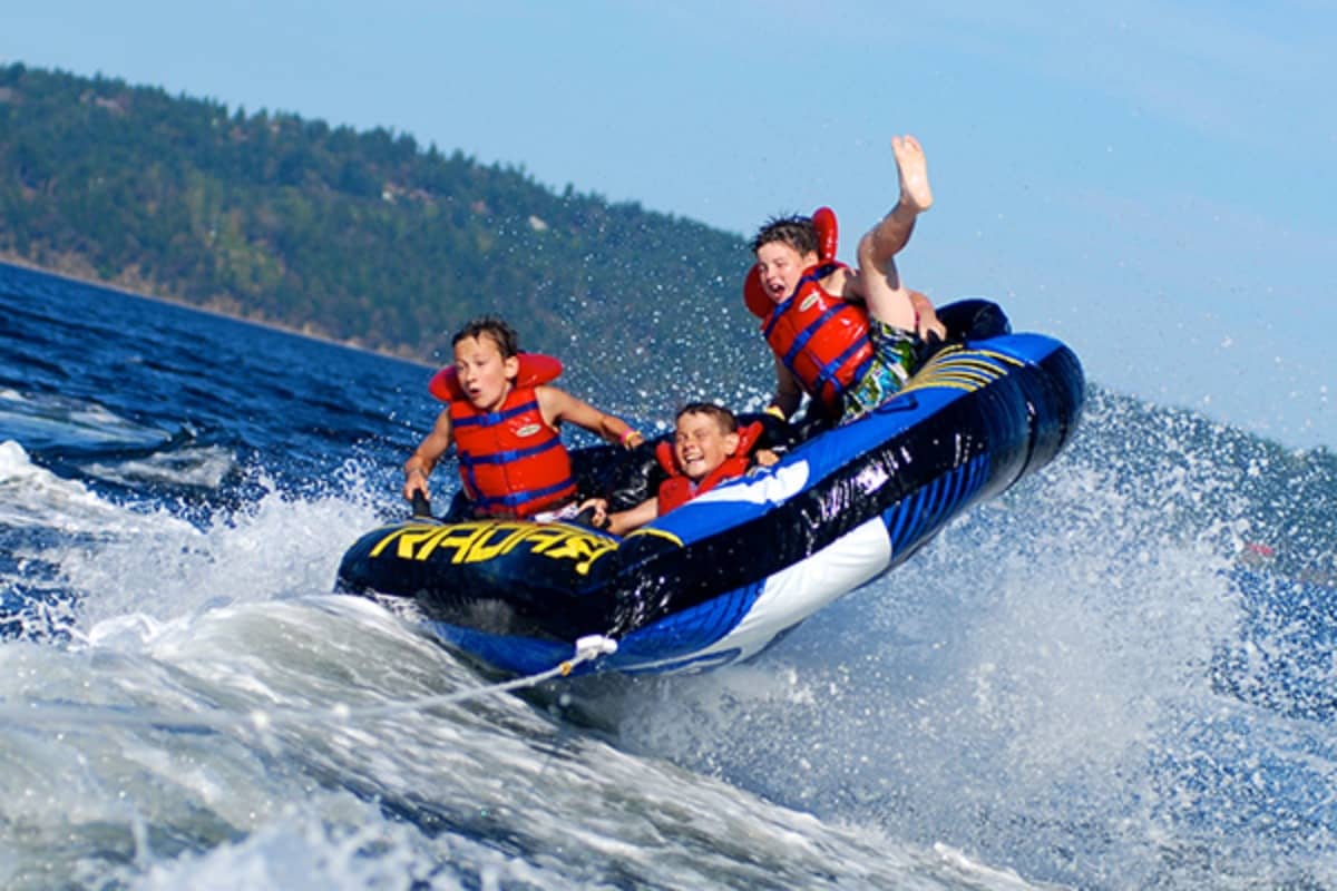 Kids having fun while being pulled by a boat