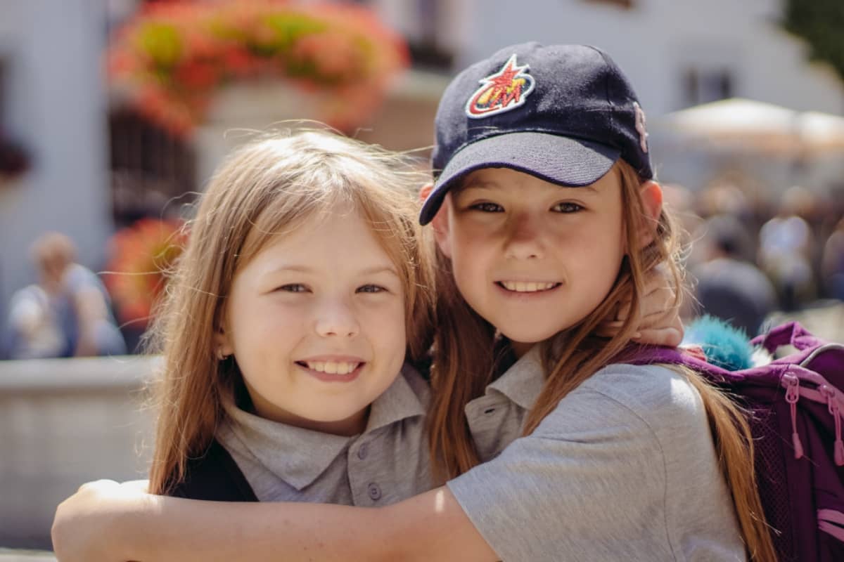 Two girls hugging each other at camp