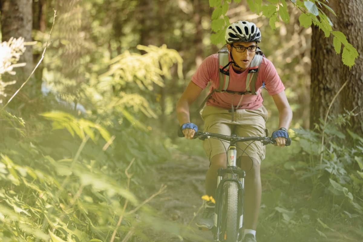 Boy going on a bike ride in the forest