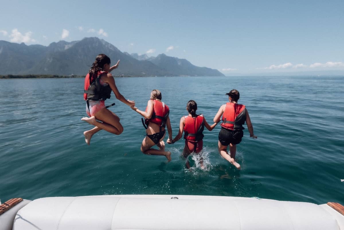 Kids jumping into water at Camp Suisse