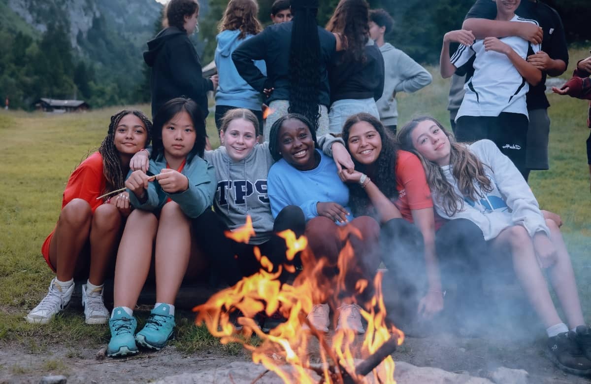 Girls enjoying a camp fire