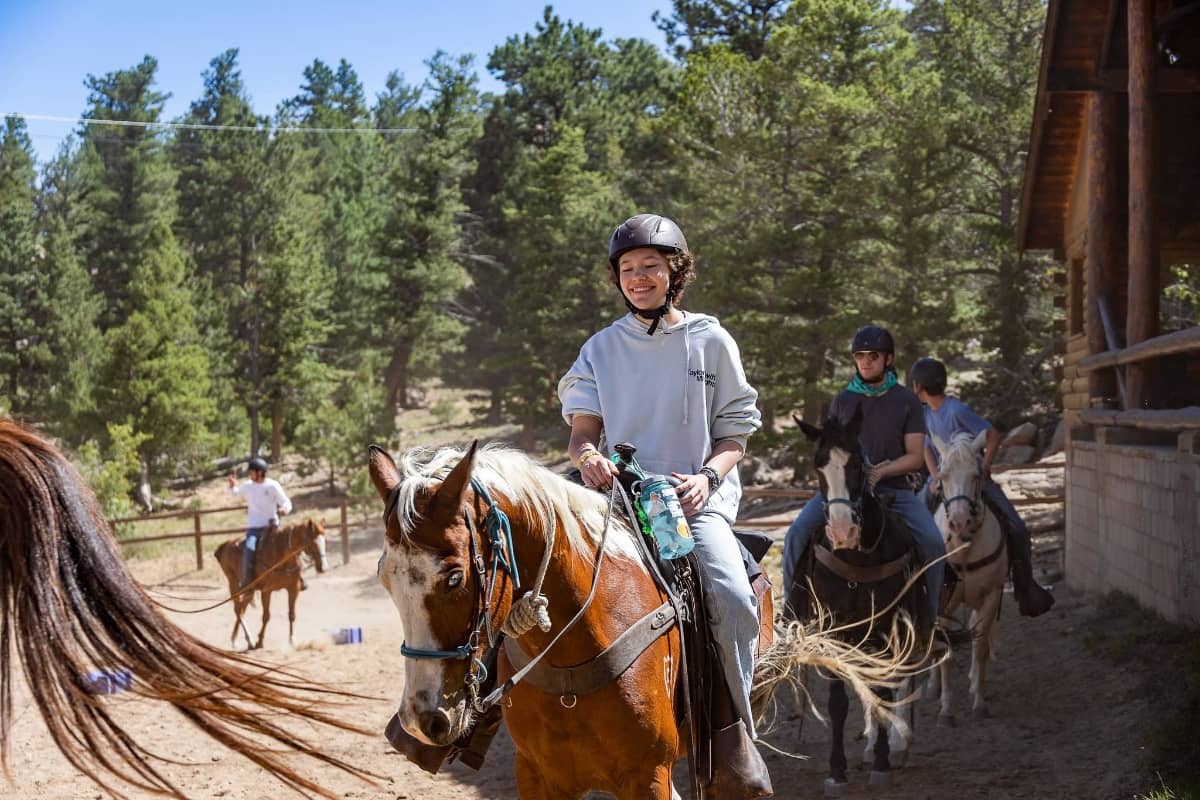 Girl horseback riding at Cheley Camps