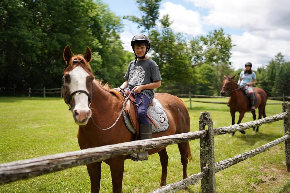 Young boy horseback riding