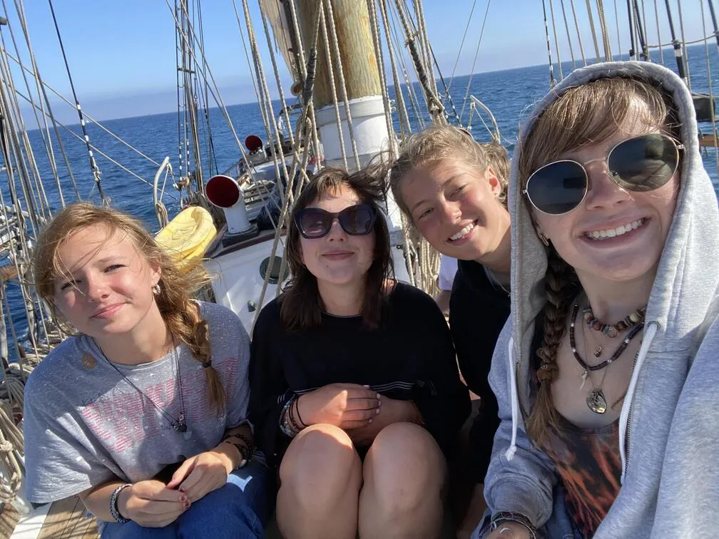 Girls taking a selfie together while sailing