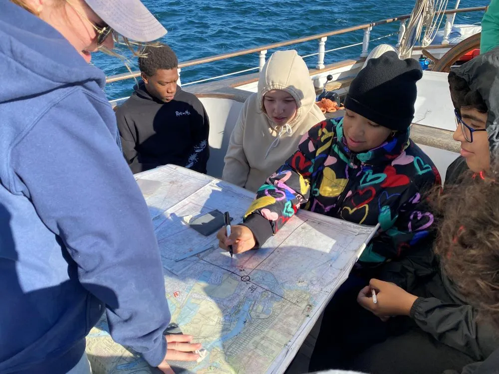 Campers looking at a map of their chartering voyage