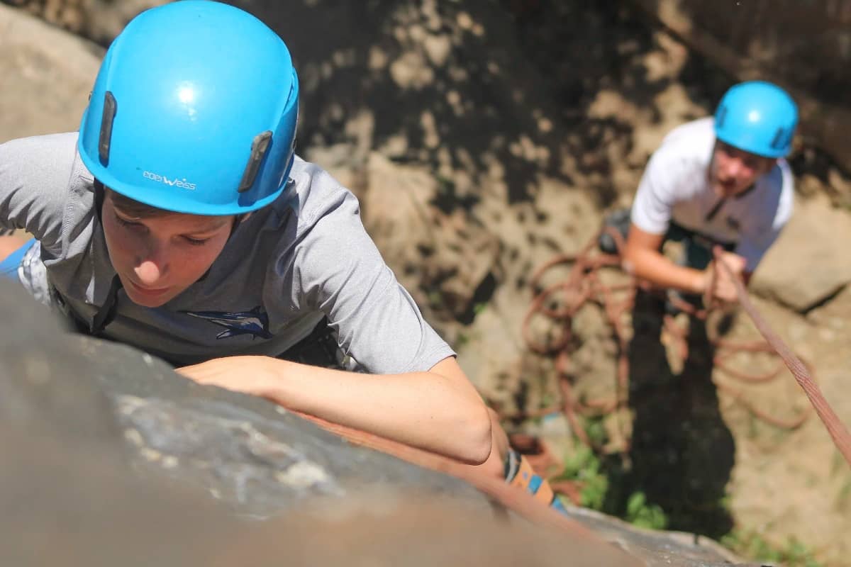 Two campers doing rock climbing together
