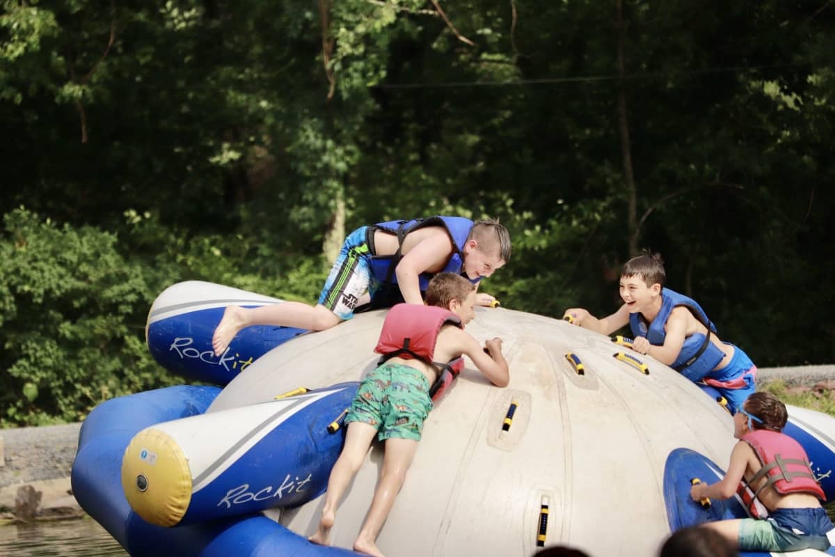 Kids playing with inflatable at Pinemere Camp