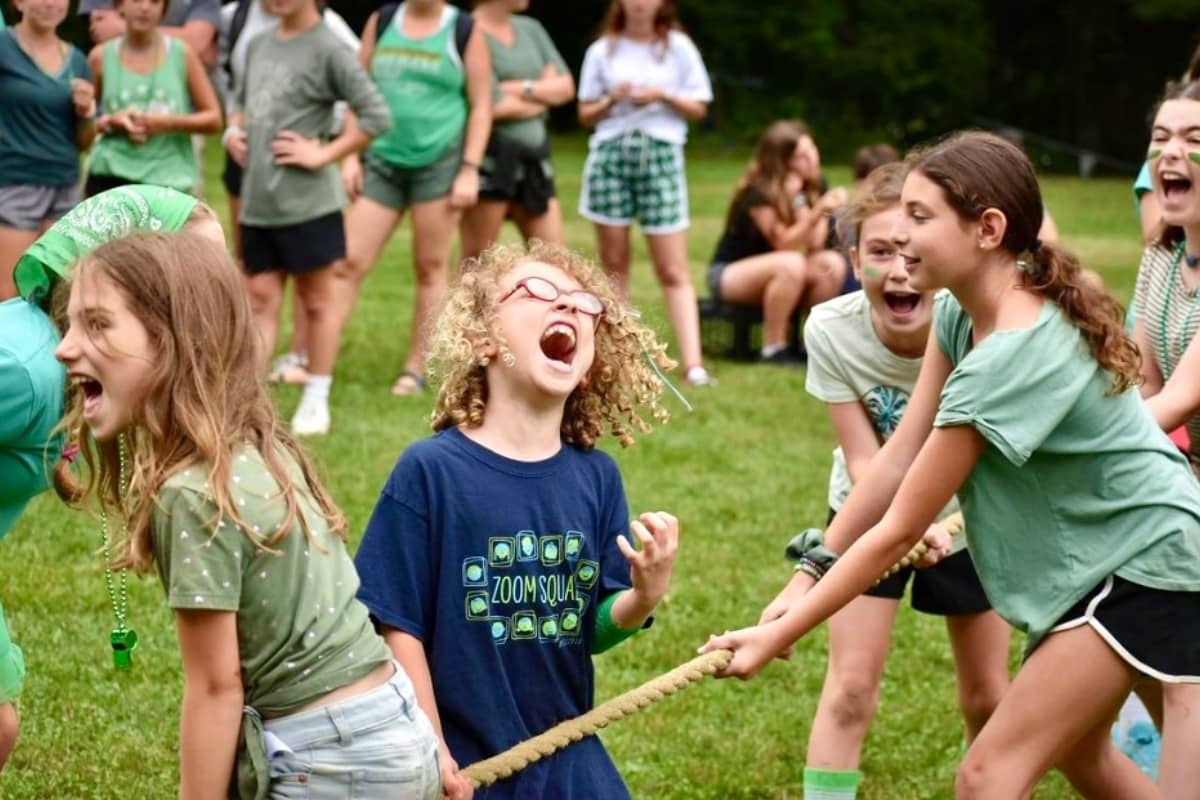 Girl campers playing tug of war