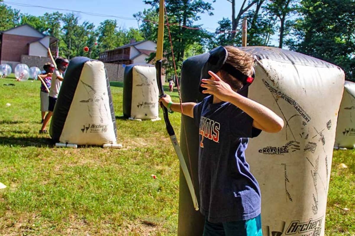 Kids playing archery tag at River Valley Ranch