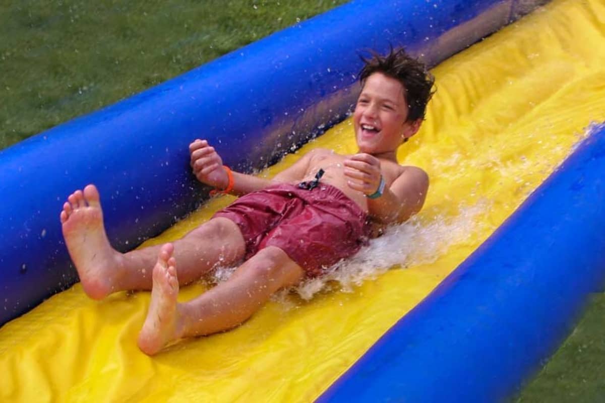 Boy going down water slide