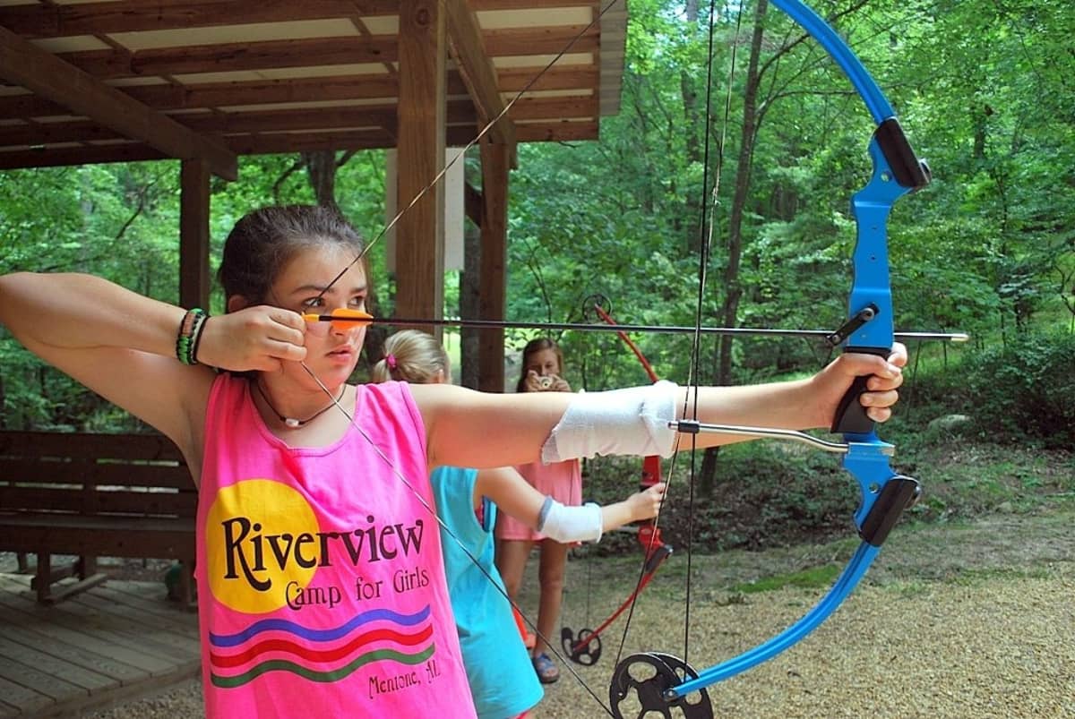Young camper doing archery at River Camp For Girls