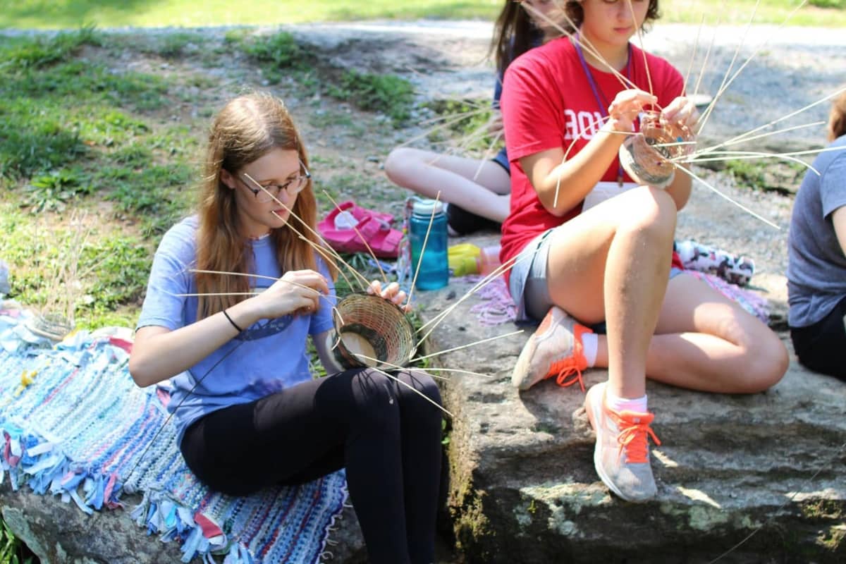 Two girls weaving