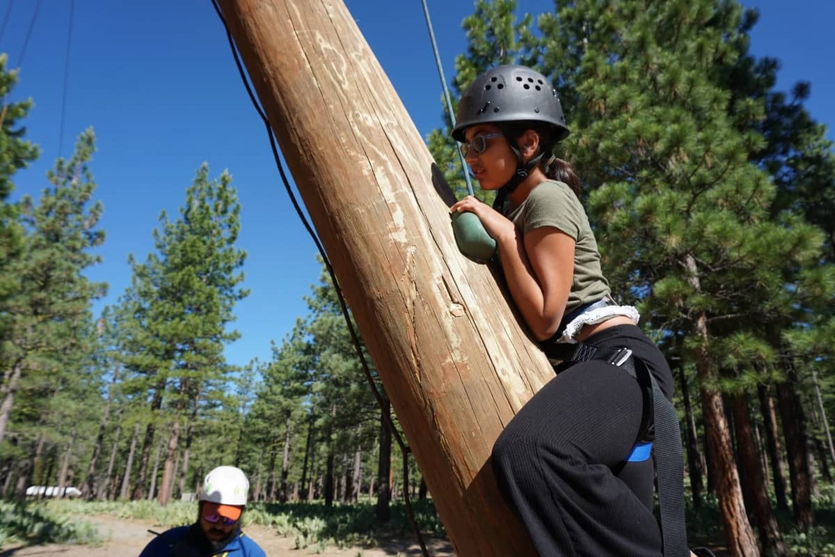 Girl climbing in a ropes course