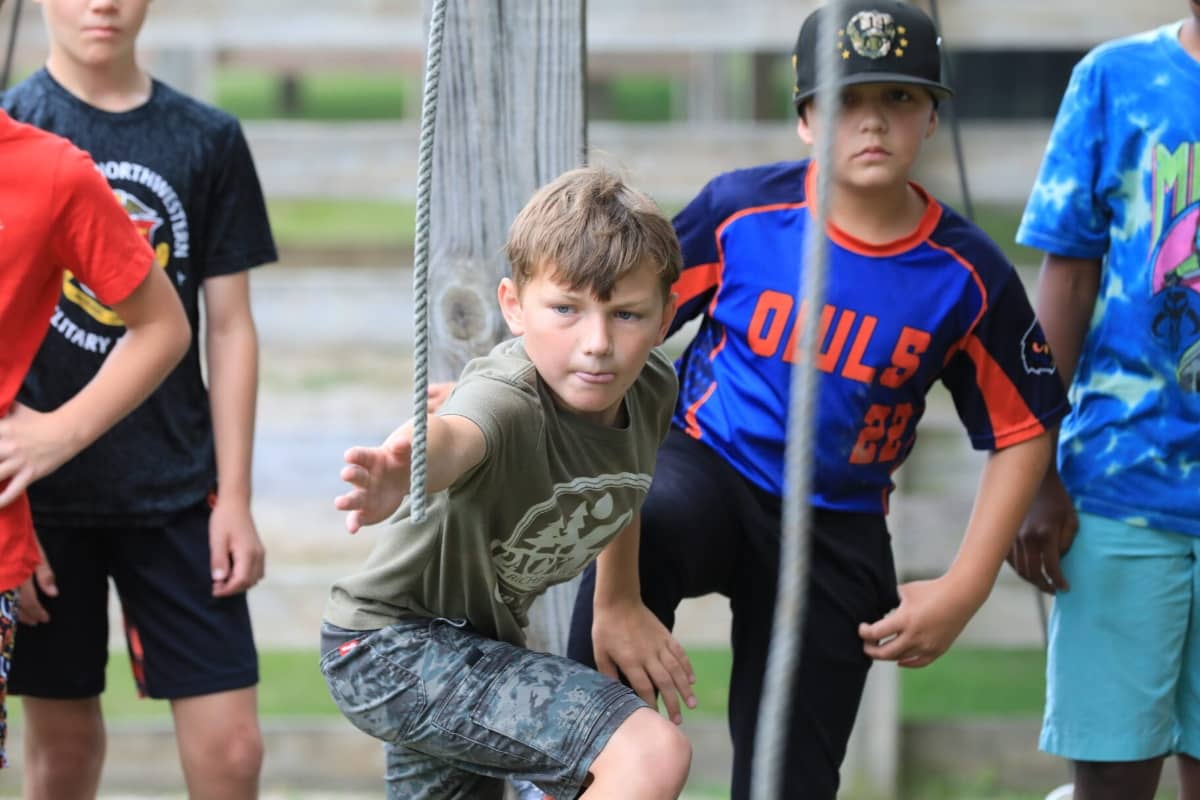Boy attempting a ropes course