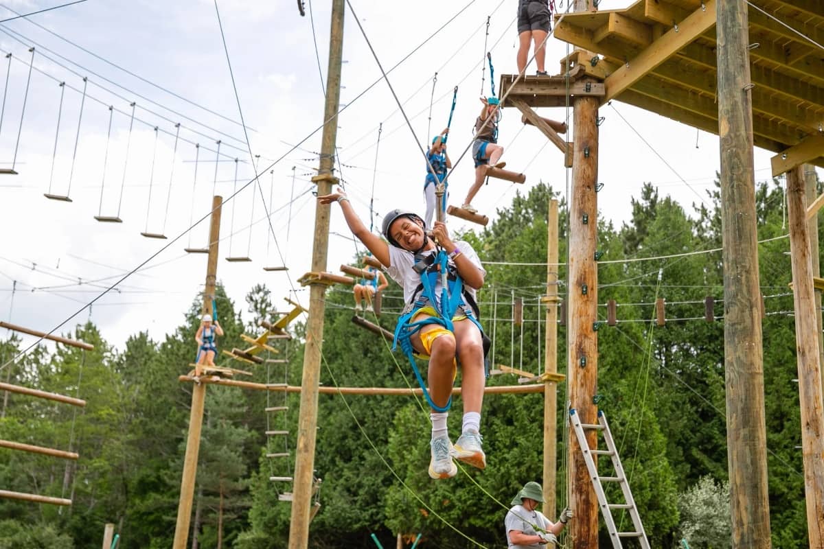 Girl on ropes course at The Woods