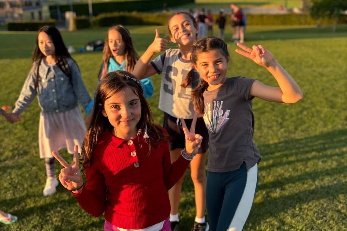 Campers throwing up the peace sign