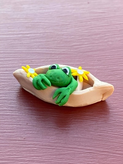 frog in a boat clay figure
