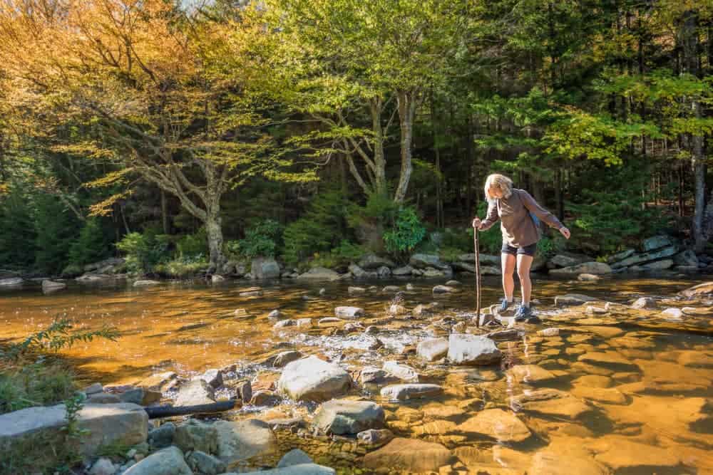 Kid crossing stream West Virginia